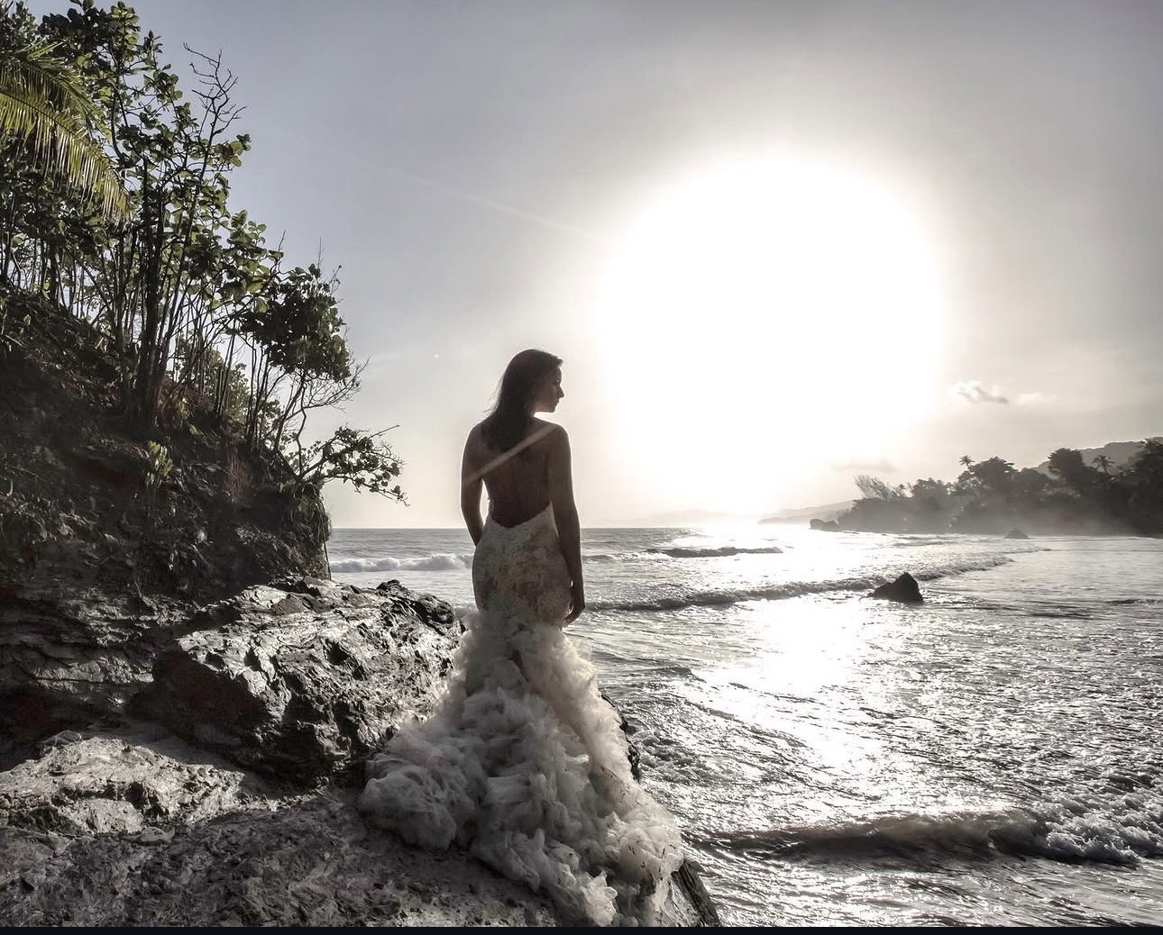 Bride on coastal rocks overlooking the ocean