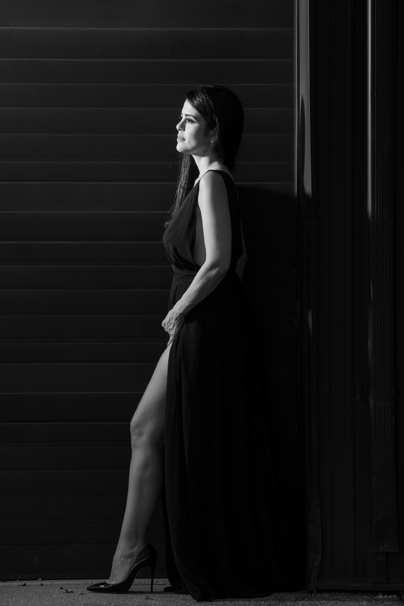 Black-and-white editorial personal branding portrait of a woman in a black dress