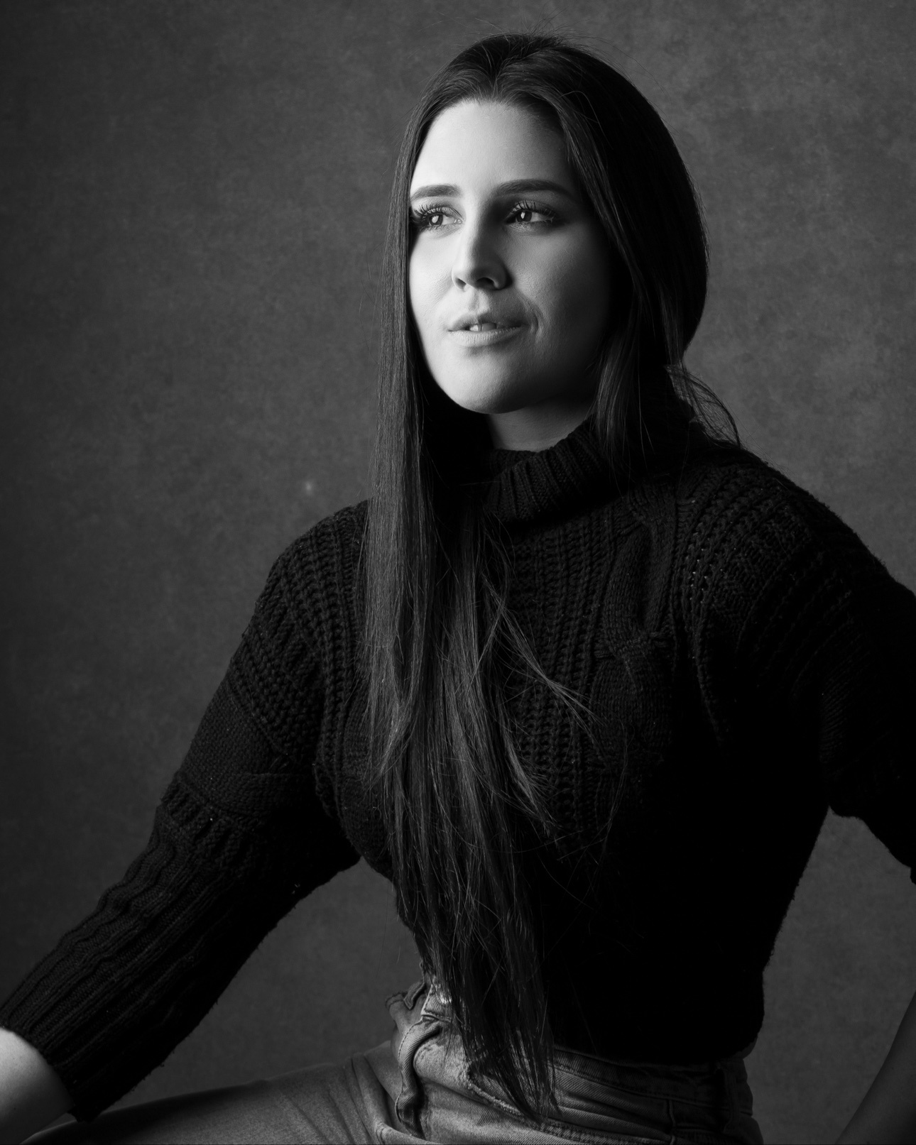 Black-and-white executive portrait of a woman in a turtleneck
